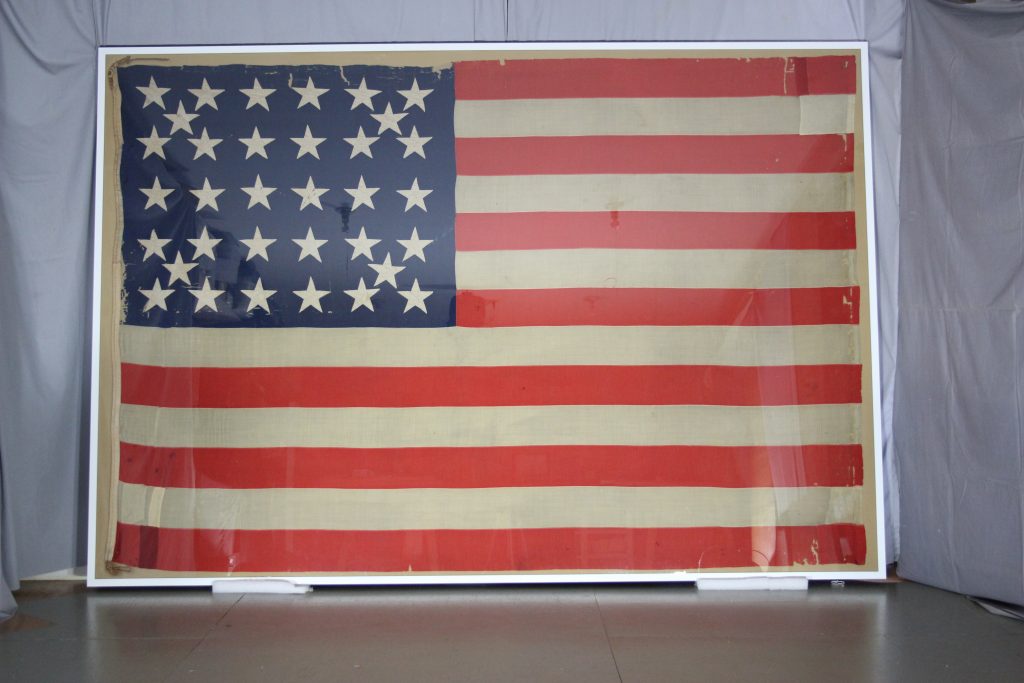 After conservation of historic civil war battle flag, pressure mount of textile, flag repair, conservation, preservation, 