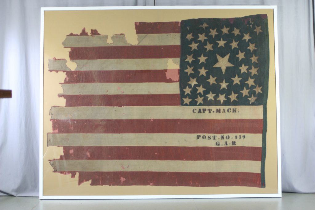 Pressure mount of historic battle flag, Civil War flag, 38 star flag, preservation of flag, repair of antique textiles, conservator and textile expert Gwen Spicer
