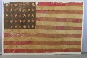 29th Missouri flag before treatment, conservation, preservation and archival mounting, pressure mount of historic battle flag from the Civil War
