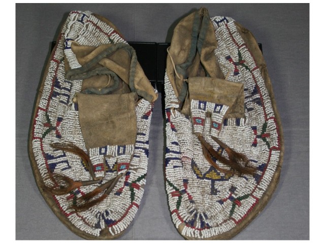 Iroquois beaded leather moccasins before conservation treatment and stabilization repair and display for museum collection by spicer Art Conservation, experts in the conservation of Native American object, paper, textile artifacts
