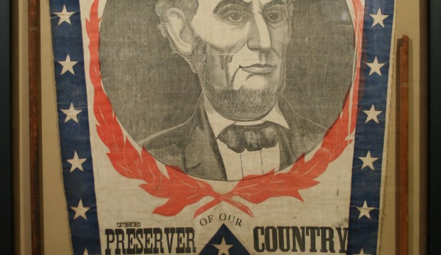 Historic banner textile from the Lincoln presidential campaign conserved and mounted in an archival frame.
