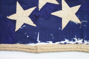 Close-up of canton of Civil war flag showing damage and previous repairs